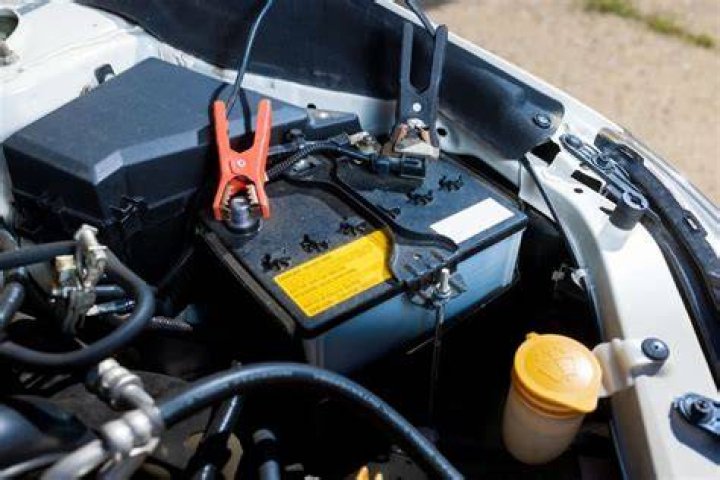 Can I charge a car battery without disconnecting it